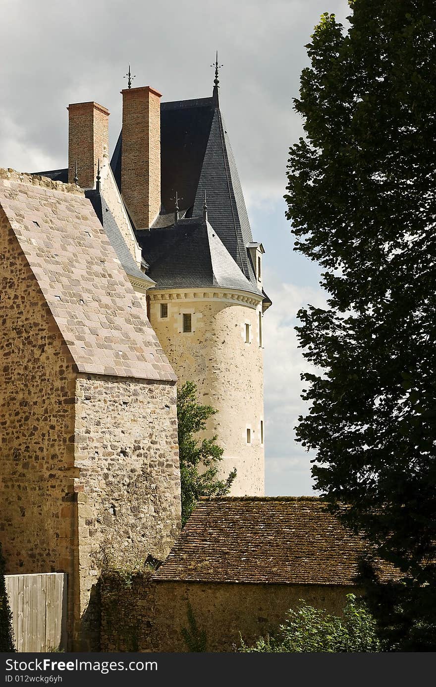 A French castle tower seen against moody skies. A French castle tower seen against moody skies