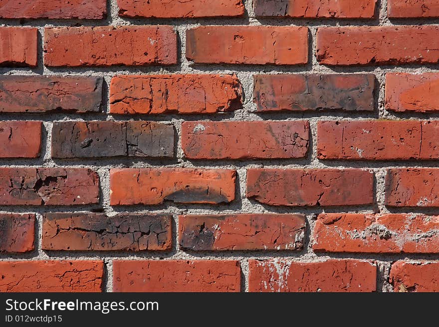 A wall of older red bricks with white mortar, aged over the years. A wall of older red bricks with white mortar, aged over the years.