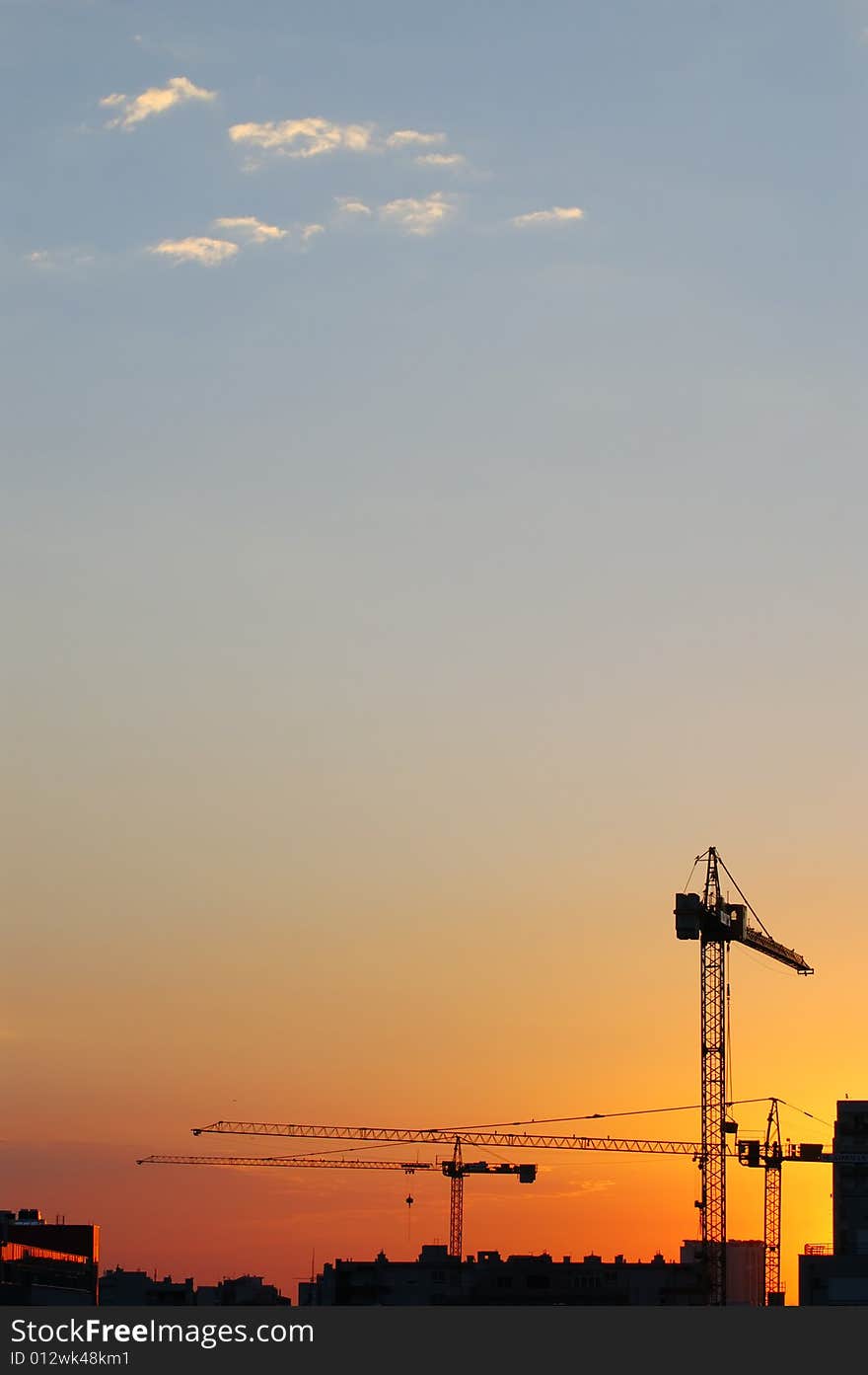 Construction site - cranes at dawn (vertical version)