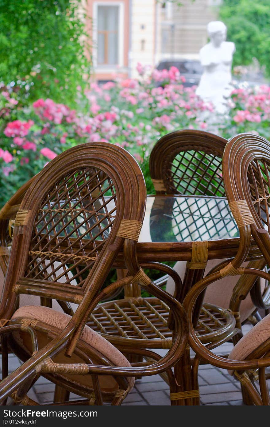 Chairs standing by the table at closed restaurant in the street