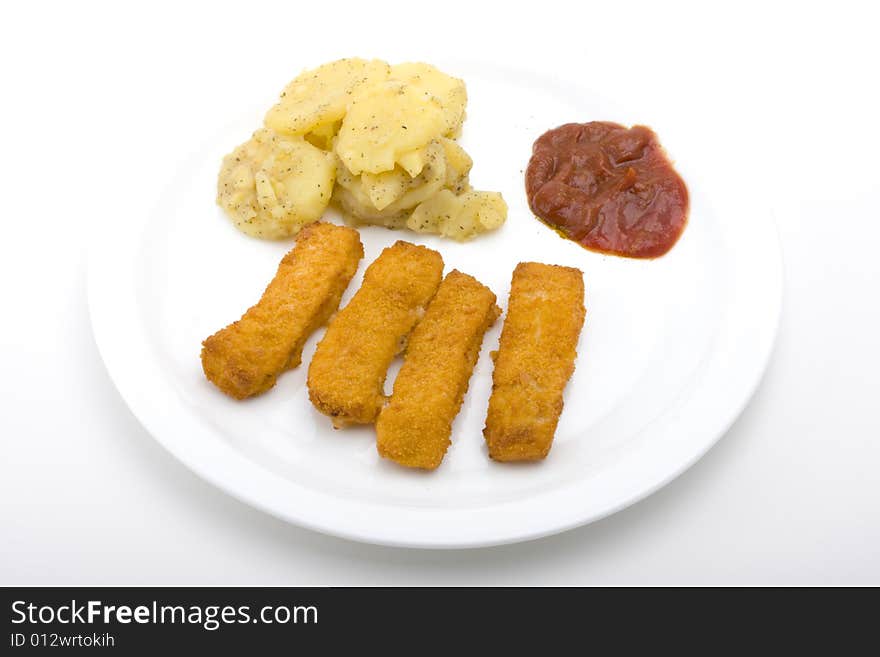 Fish fingers with potatoe salad on a white plate