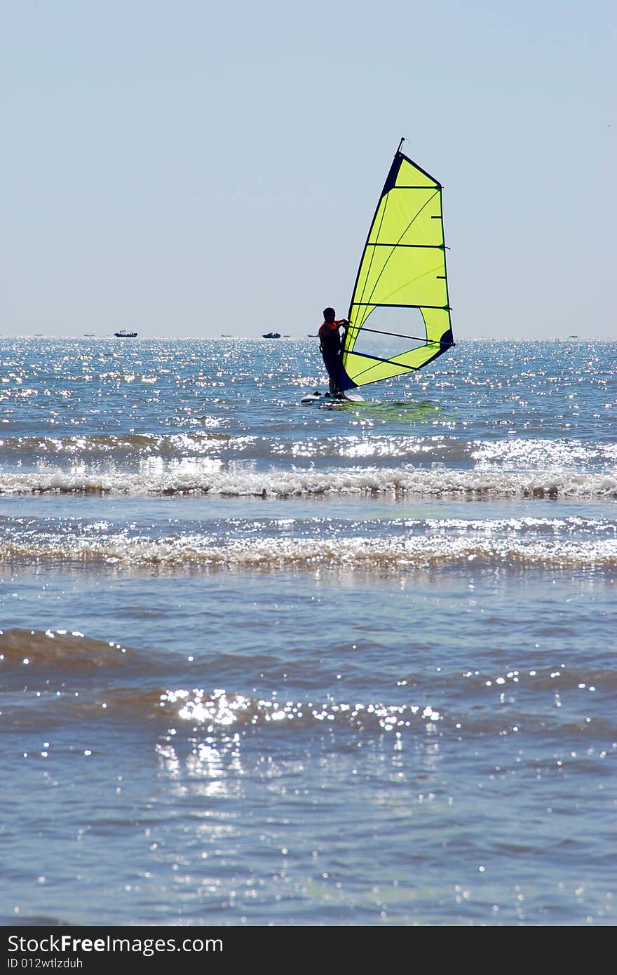 A sailboarder on the water at nandaihe, china. A sailboarder on the water at nandaihe, china