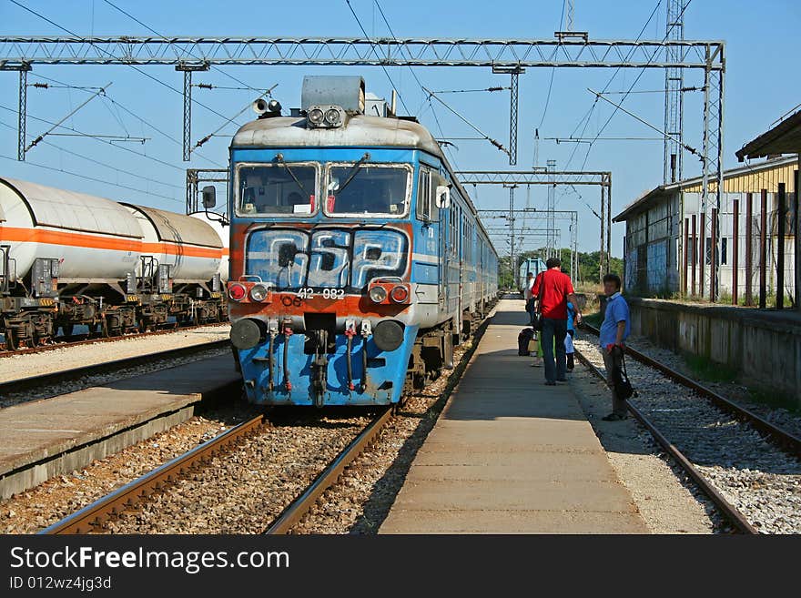 Passenger train enter in small station.