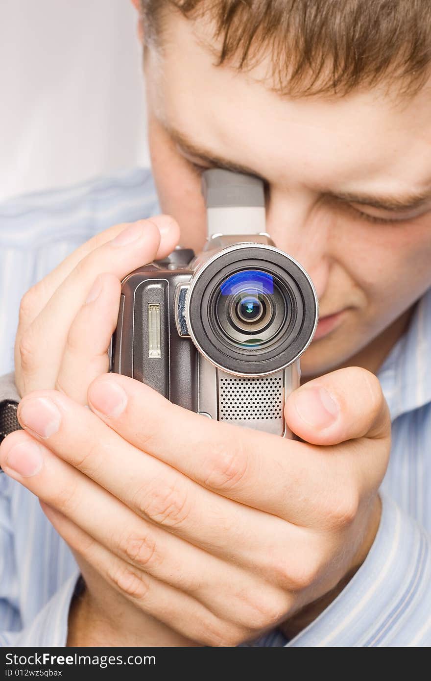 Closeup man portrait with videocamera in hands