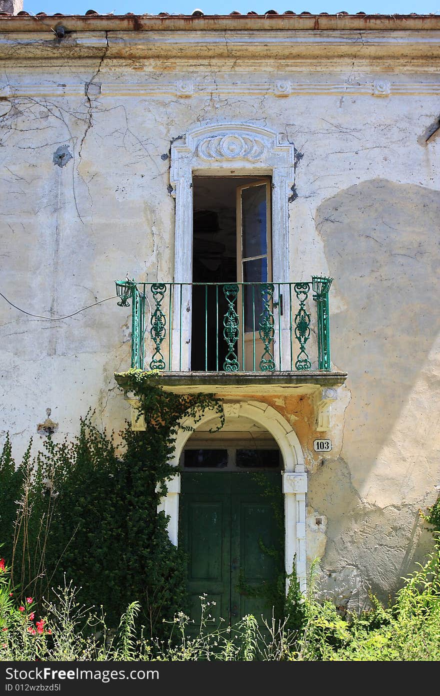 The front side entrance of a run down abandoned old farmhous in southern Europe. The front side entrance of a run down abandoned old farmhous in southern Europe