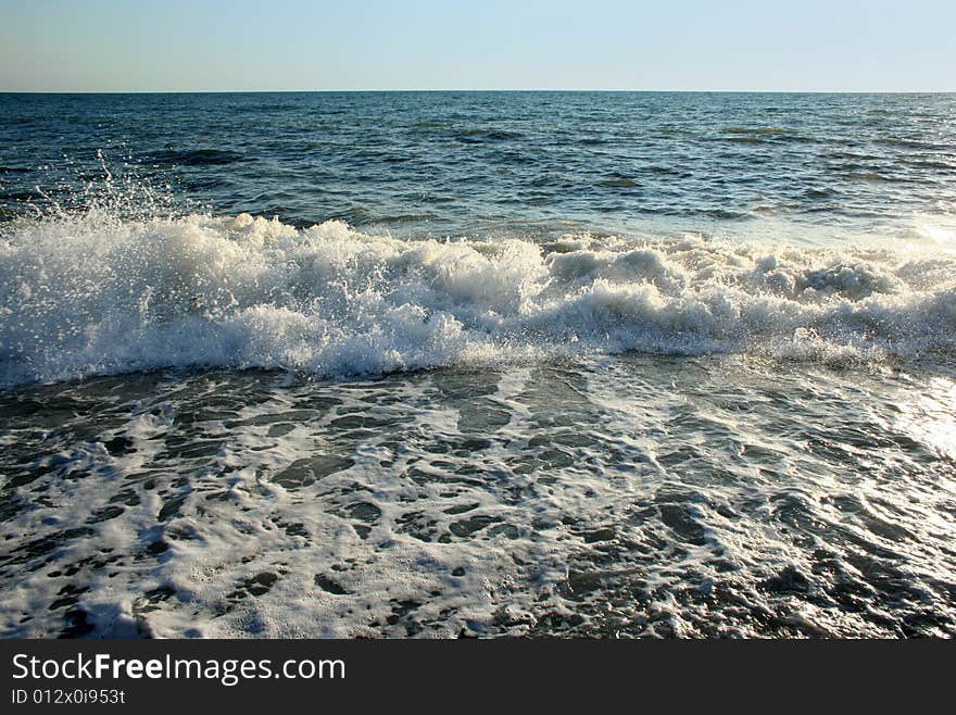 Wave on sea beach under year blue sky and cloud