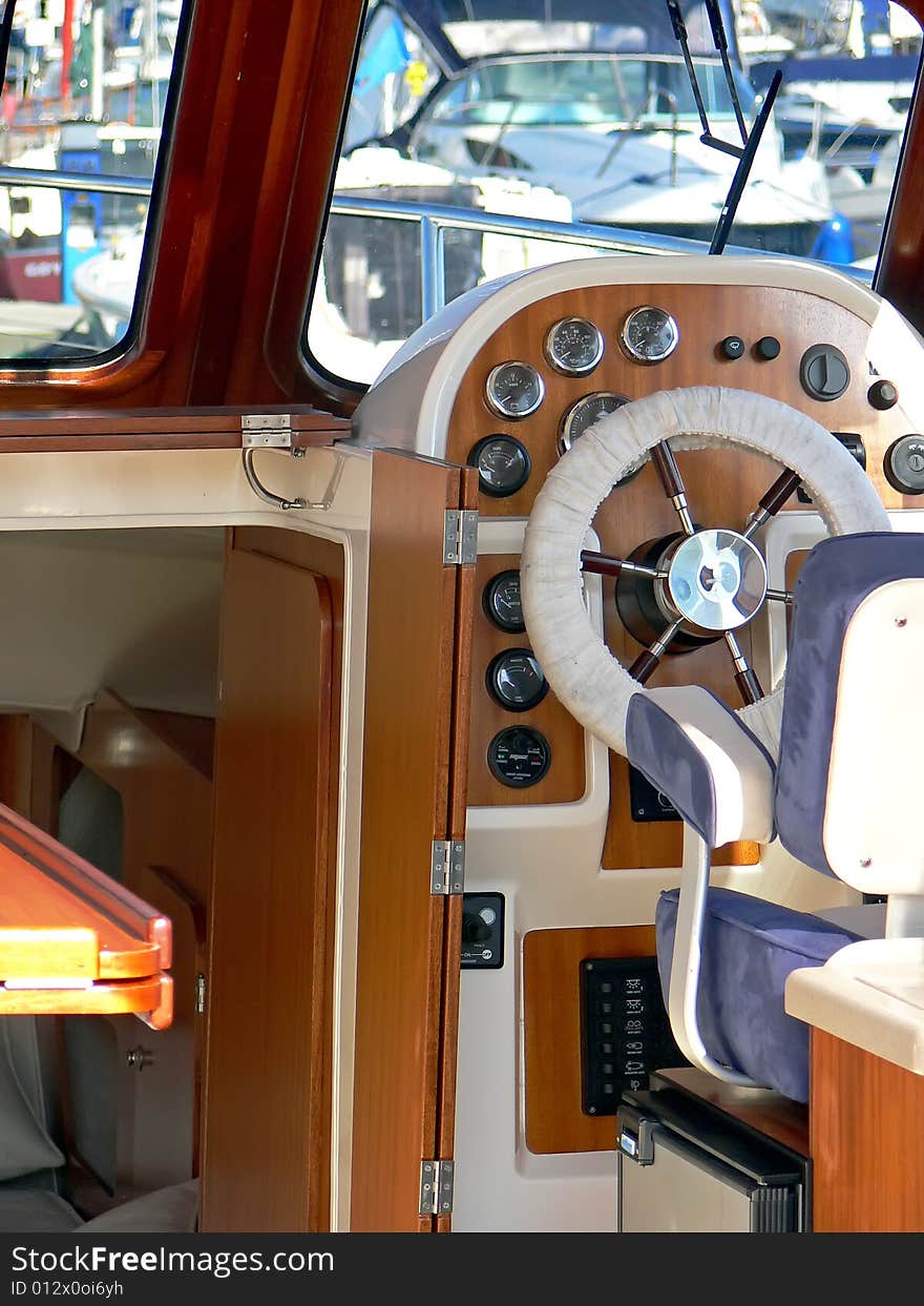 Motor boat wheel and stylish control panel close up.