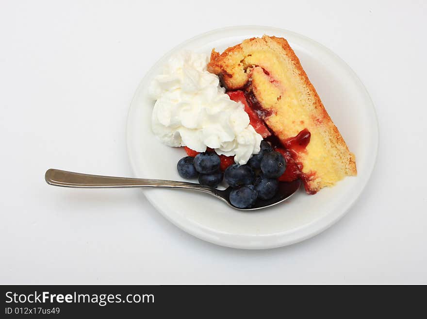 Slice of strawberry cake with whipped cream and blueberries isolated on white. Slice of strawberry cake with whipped cream and blueberries isolated on white