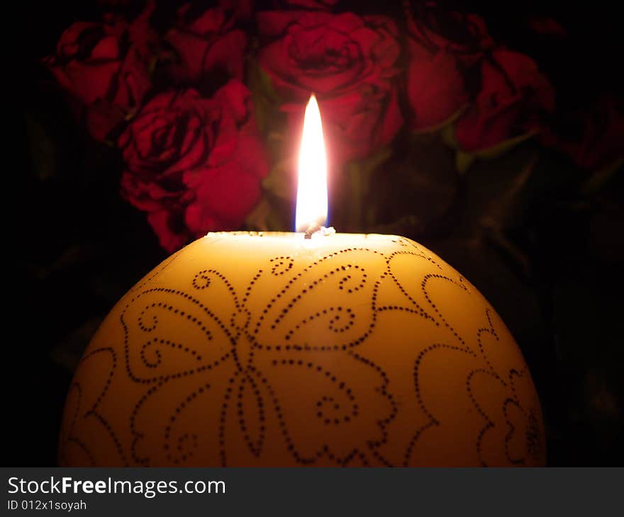 Light round candle with butterfly near roses. Light round candle with butterfly near roses