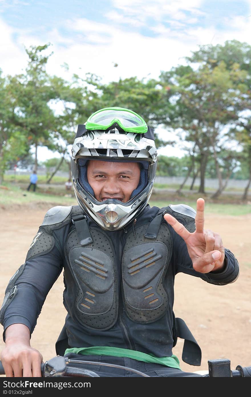 racing winner victory, Man in motocross racing costume in field