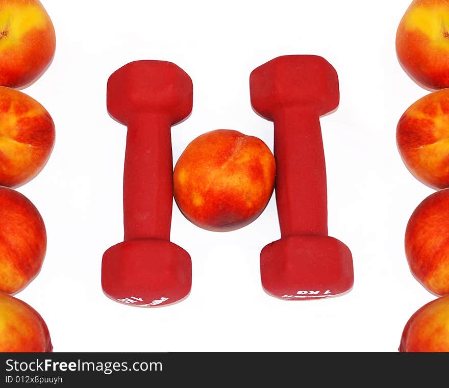 Appetizing fresh peaches and dumbbells in shape H letter. Appetizing fresh peaches and dumbbells in shape H letter