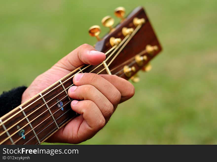 Hand of a guitarist playing a guitar