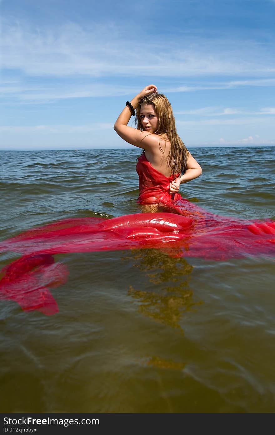 Beautiful girl swimming with red shawl