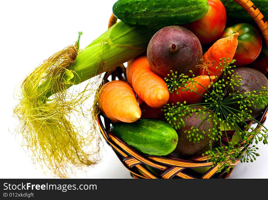 An image of various fresh vegetables in wooden backet