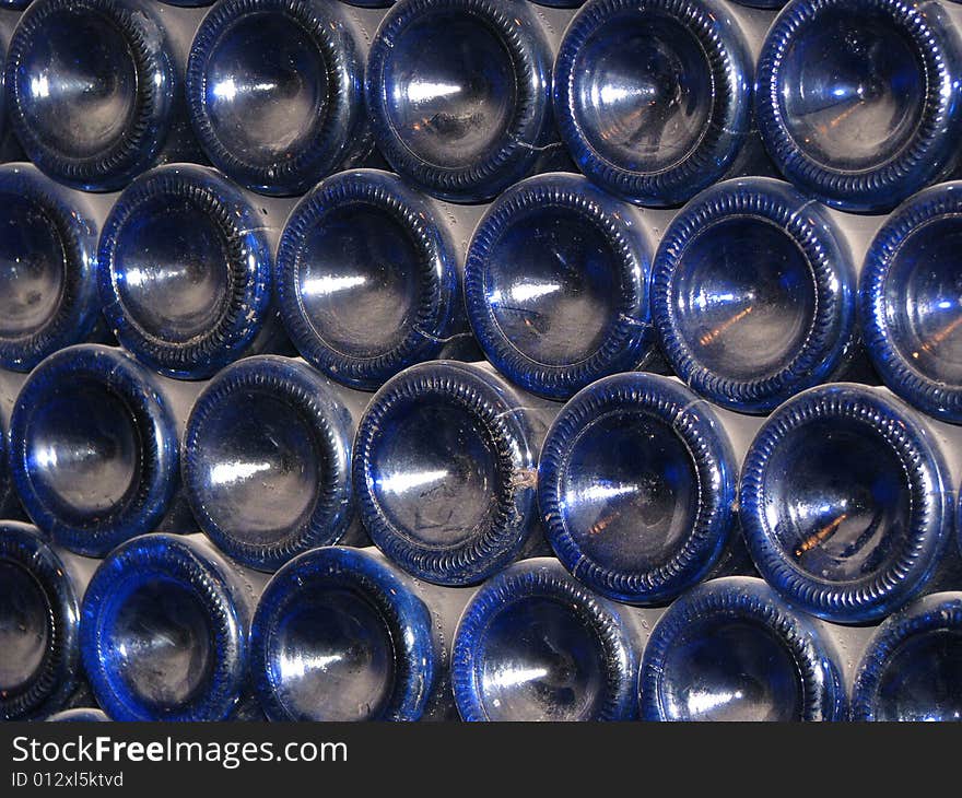 A stack of dusty blue wine bottles. A stack of dusty blue wine bottles