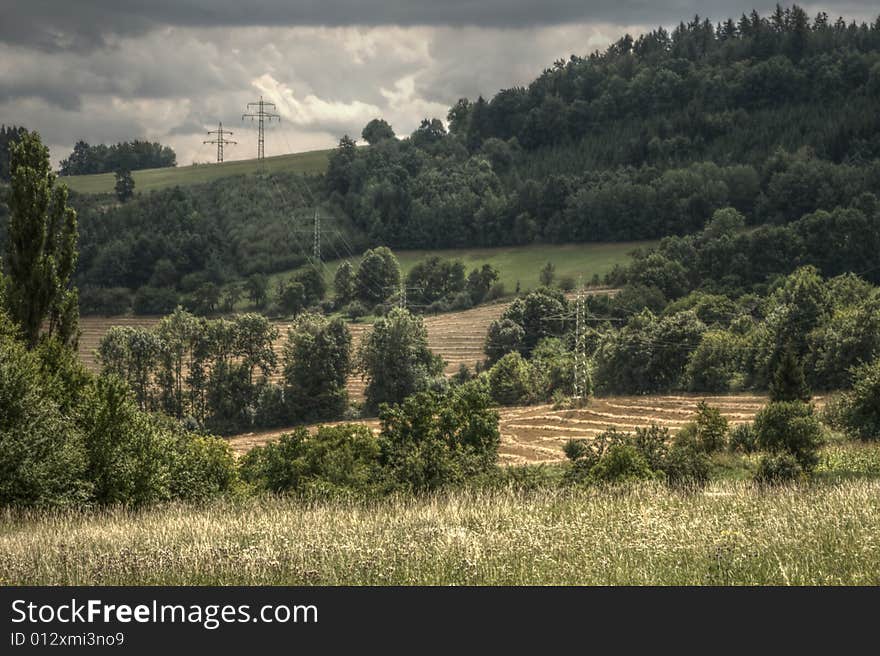 Late summer landscape from moravia with hill, trees, meadows, fields and electricity wires. Late summer landscape from moravia with hill, trees, meadows, fields and electricity wires