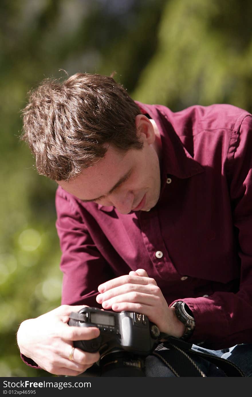 Photographer looking at camera, man with camera