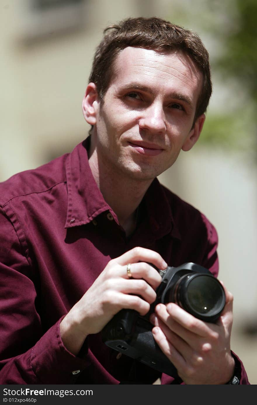 Photographer looking at camera, man with camera