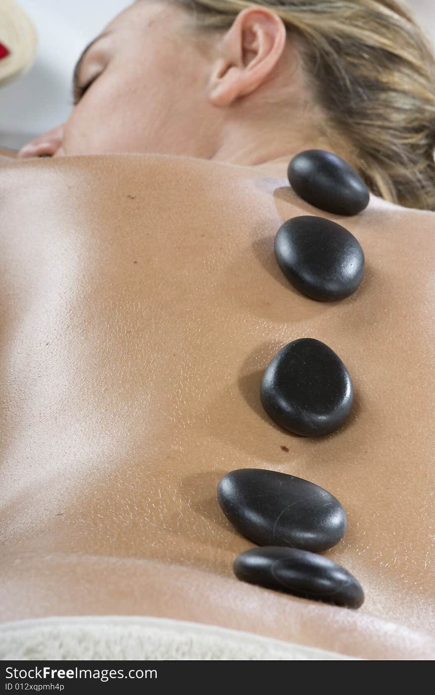 Woman having stone treatment on a spa. Woman having stone treatment on a spa