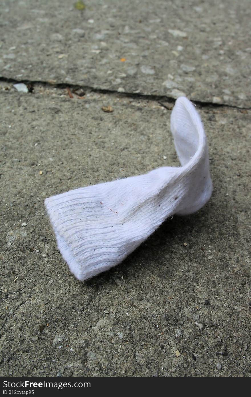 Photo of a child sock on the sidewalk. Photo of a child sock on the sidewalk