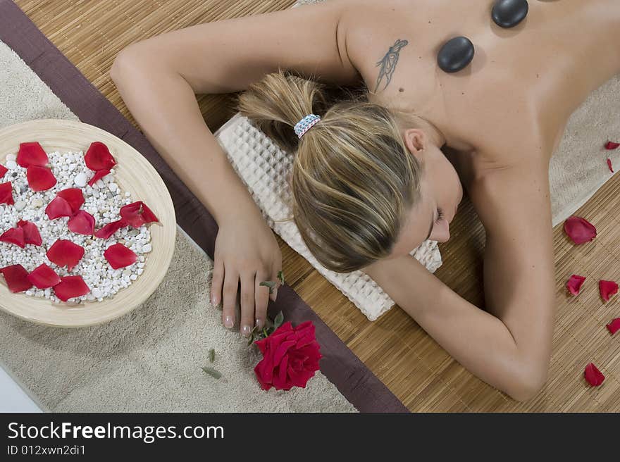 Woman having hot-stone massage