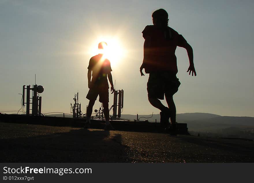 Silhouette on the roof. Sunset sky. Silhouette on the roof. Sunset sky