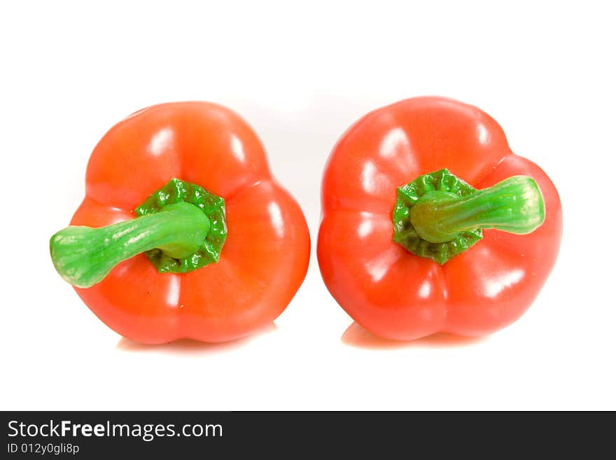 Two sweet peppers on white ground