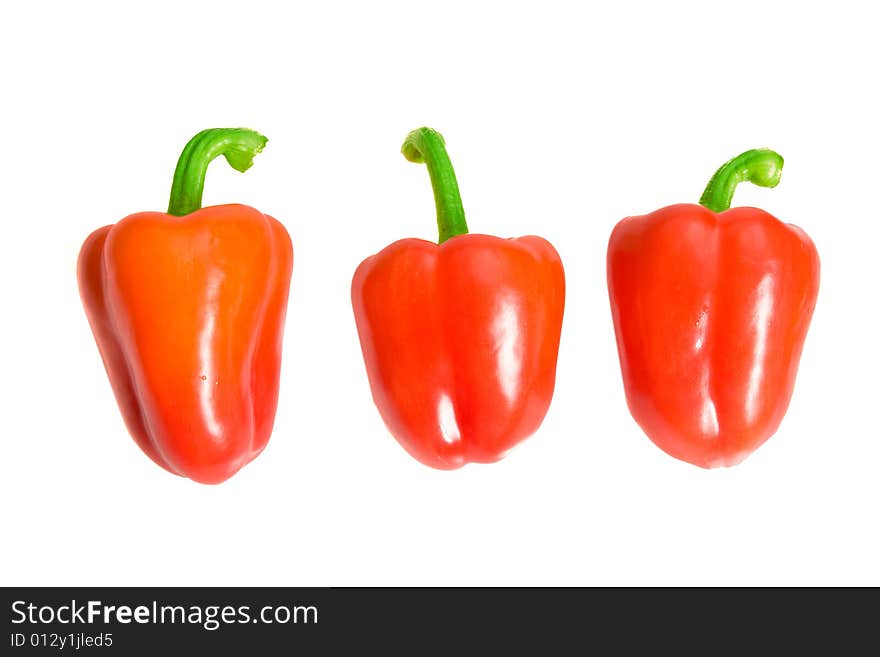 Three red sweet peppers on white ground. Three red sweet peppers on white ground