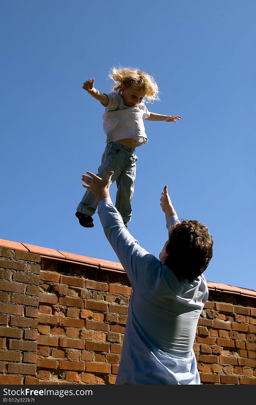 Little boy flying into his fathers hands. Little boy flying into his fathers hands