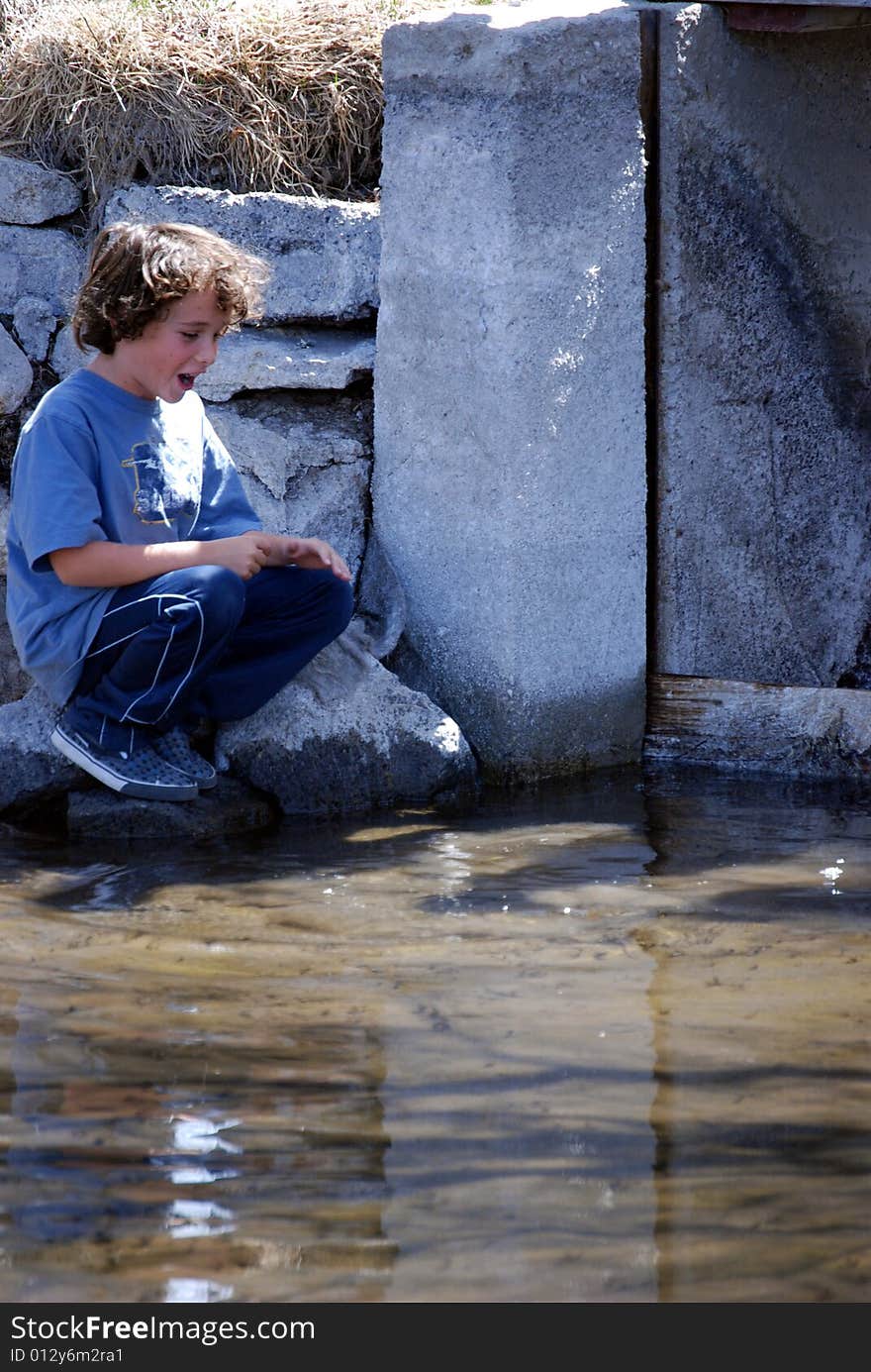 Boy Spotting Trout In Water