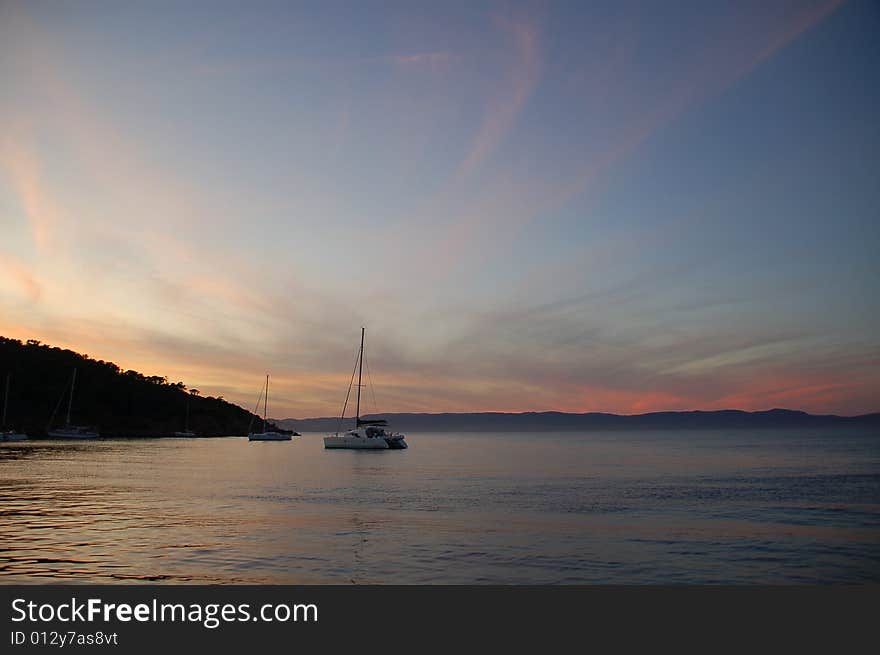 Sailboat at anchor in a bay in France at sunset. Sailboat at anchor in a bay in France at sunset