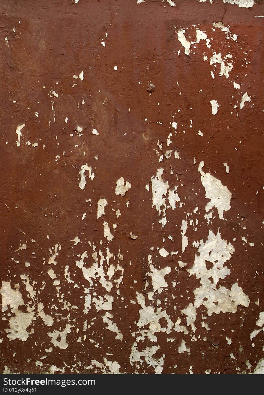 A fragment of brown old damaged wall. A fragment of brown old damaged wall