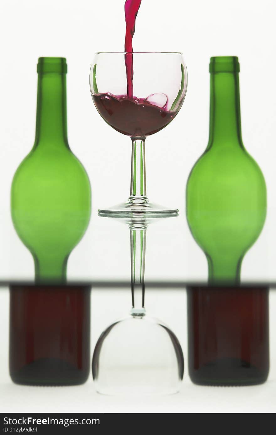 Wine pouring into a glass against semi abstract background