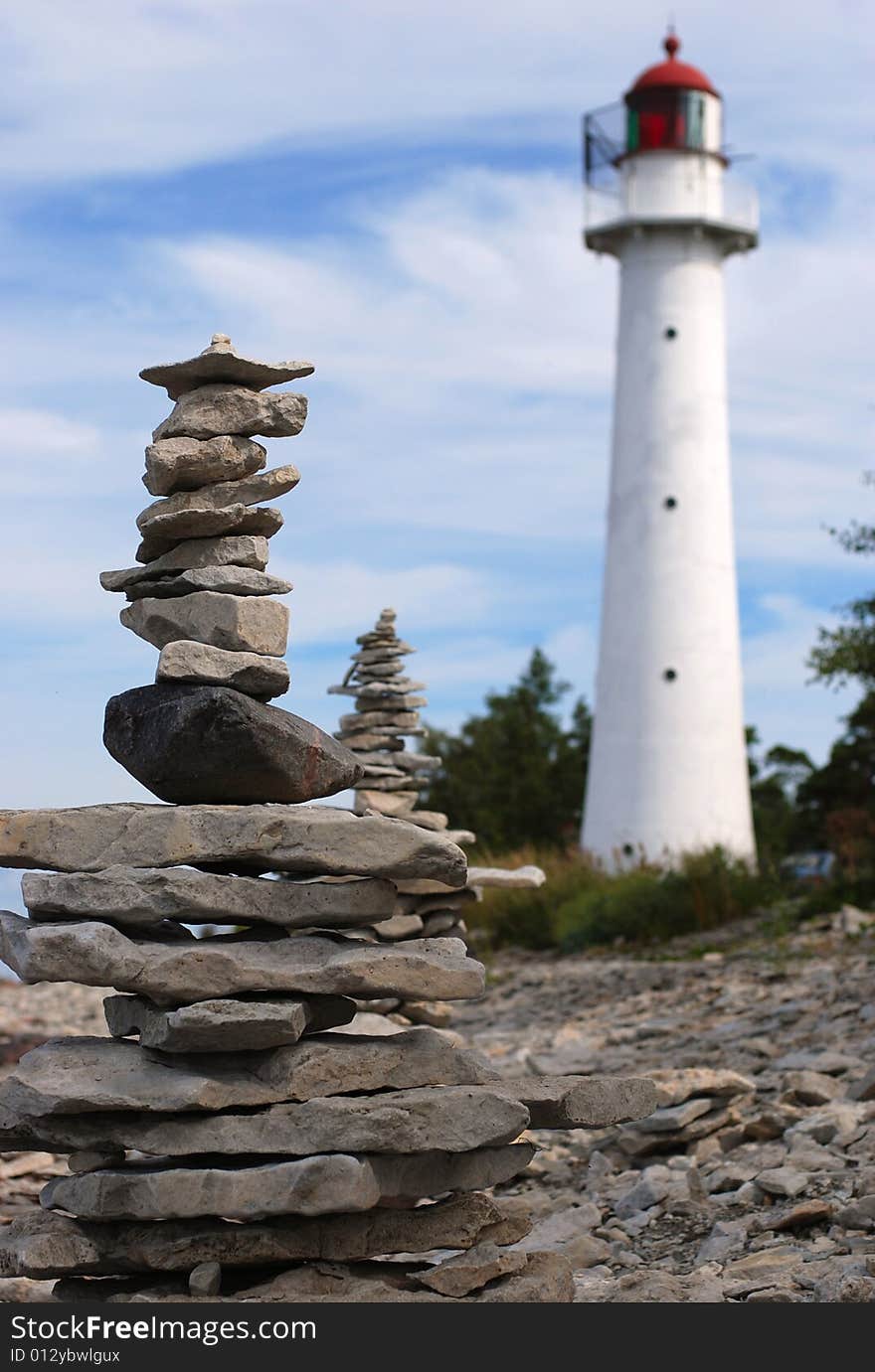 Lighthouse on the coastline and stones. Lighthouse on the coastline and stones