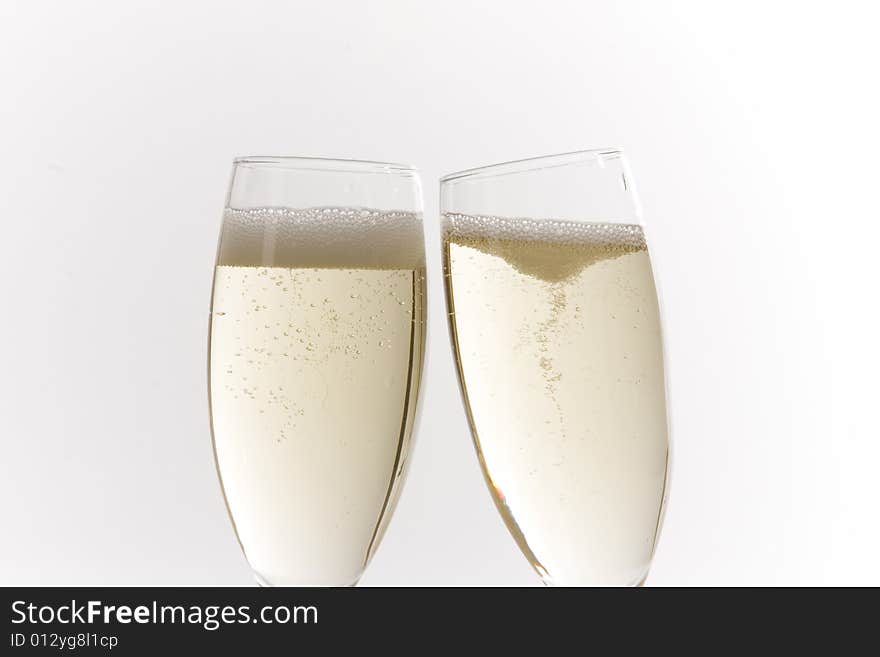 Champagne glasses on white ground