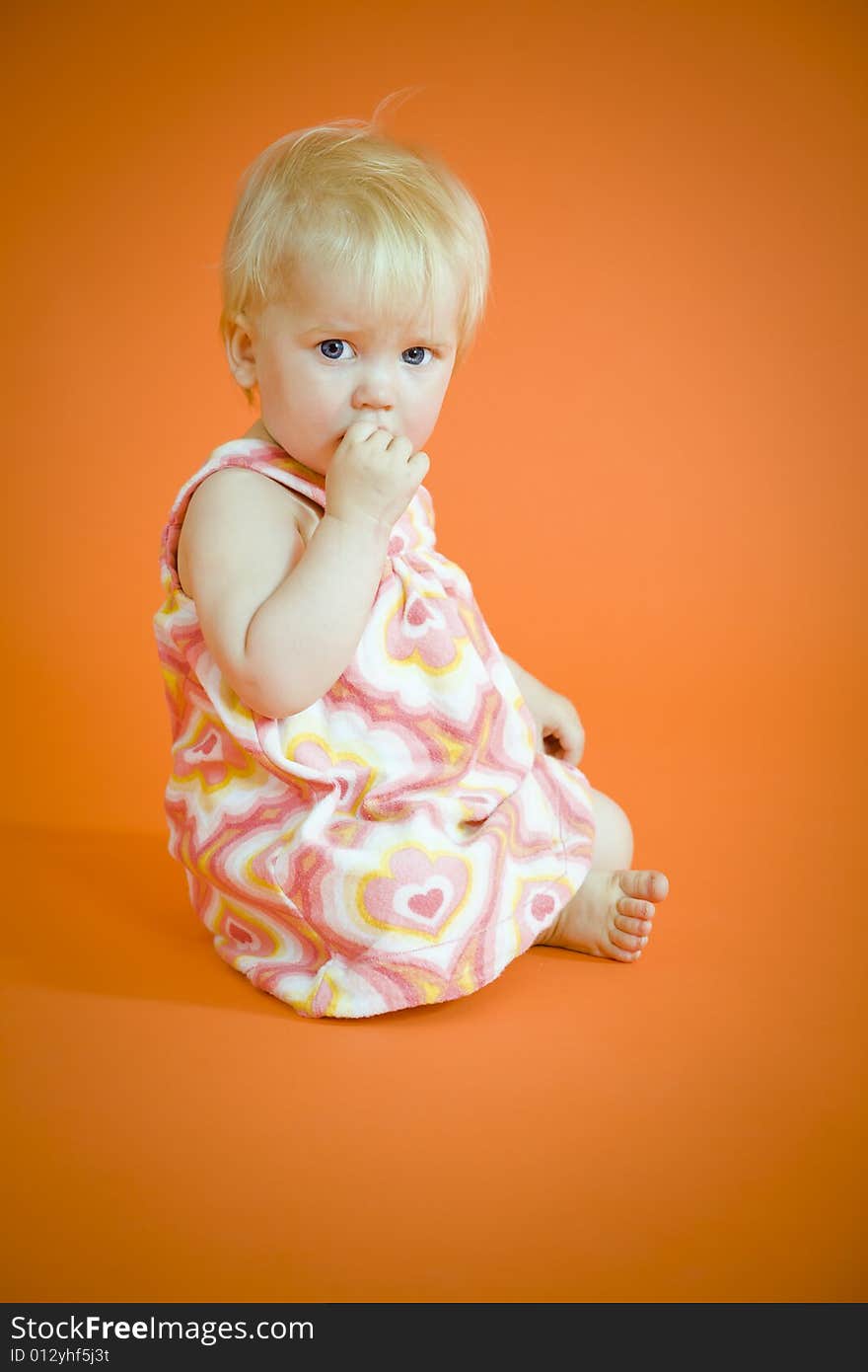 Small baby girl sitting on the floor. Small baby girl sitting on the floor