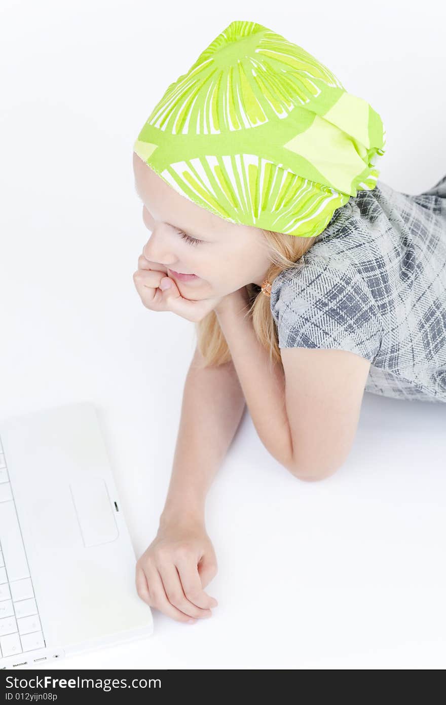 Young girl using a laptop computer over white background