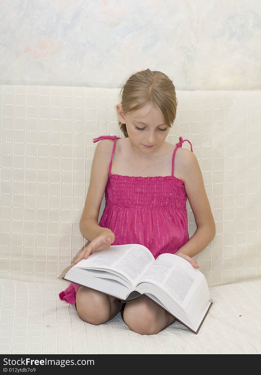 Little beautiful girl reading book