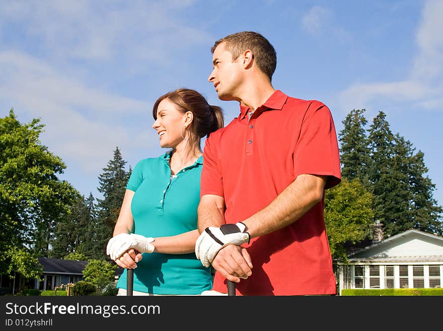 Golfers stand in front of camera. They are looking Man into the distance. Horizontally framed photo. Golfers stand in front of camera. They are looking Man into the distance. Horizontally framed photo.