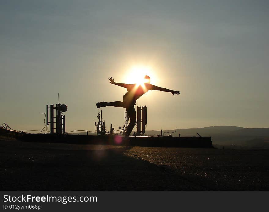 Silhouette on the roof. Sunset sky. Silhouette on the roof. Sunset sky