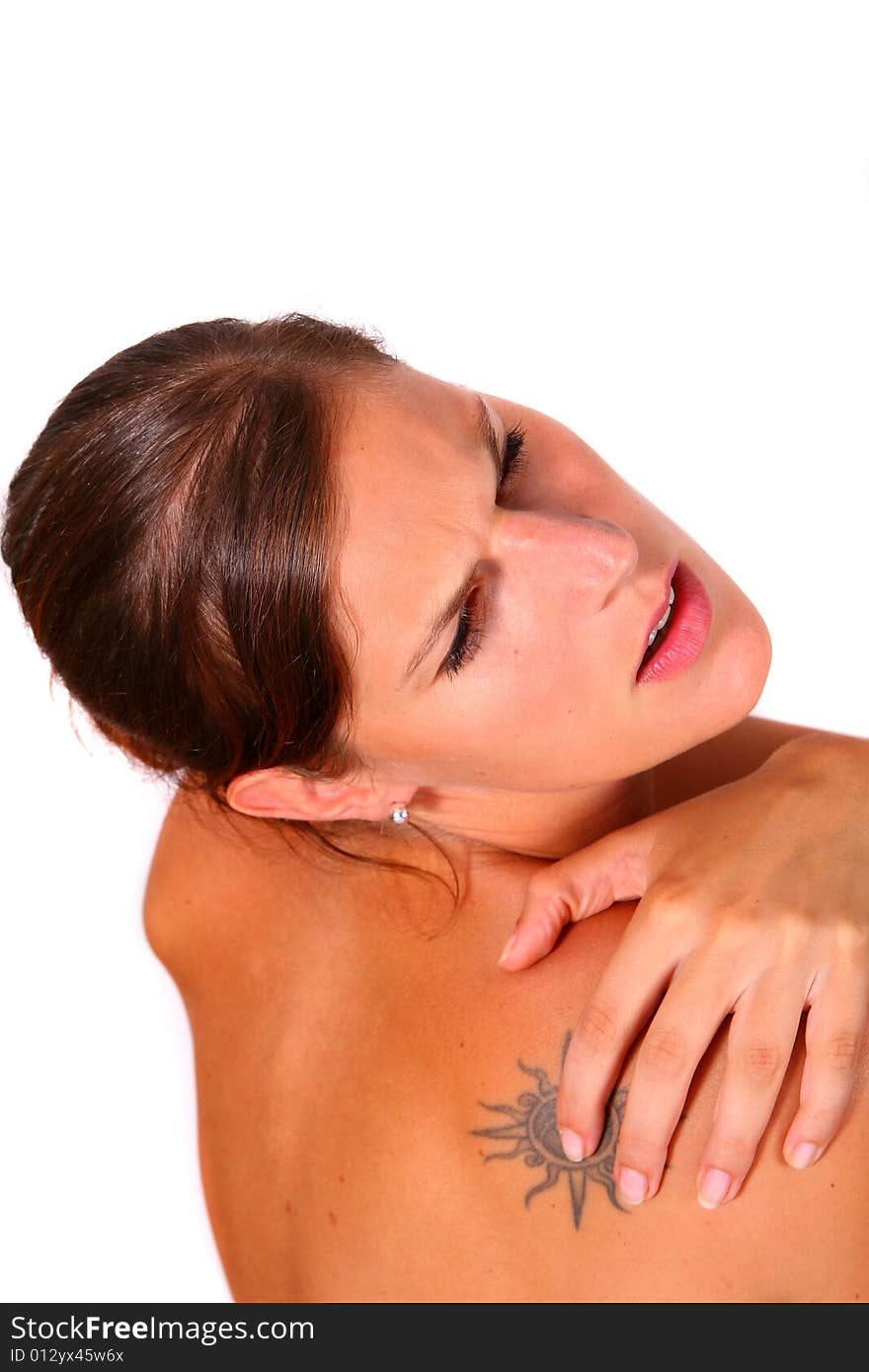 A young woman screams in pain and holds her shoulder. Isolated over white. A young woman screams in pain and holds her shoulder. Isolated over white.