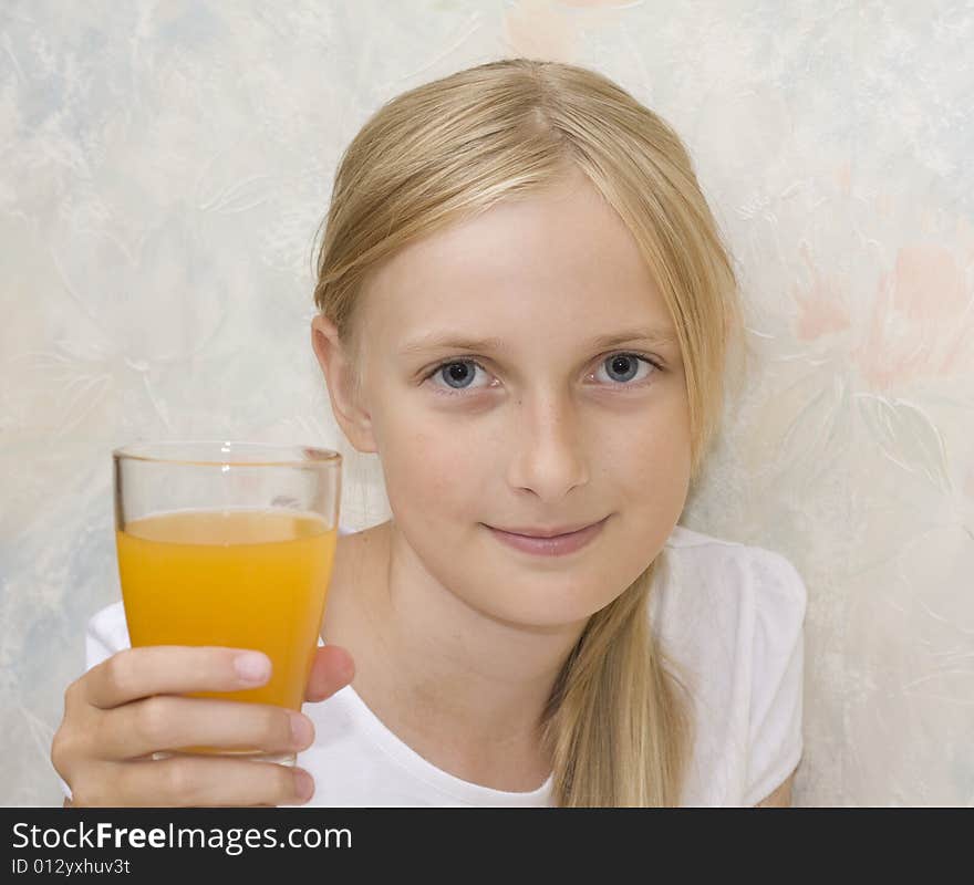 Young teenager girl drinking orange juice