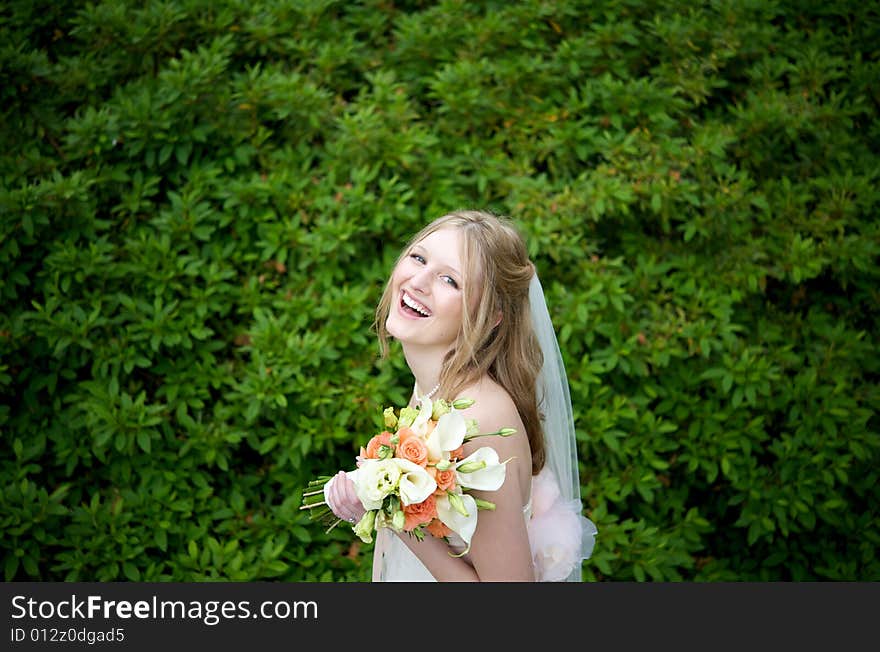 Laughing Bride Against Lush Foliage