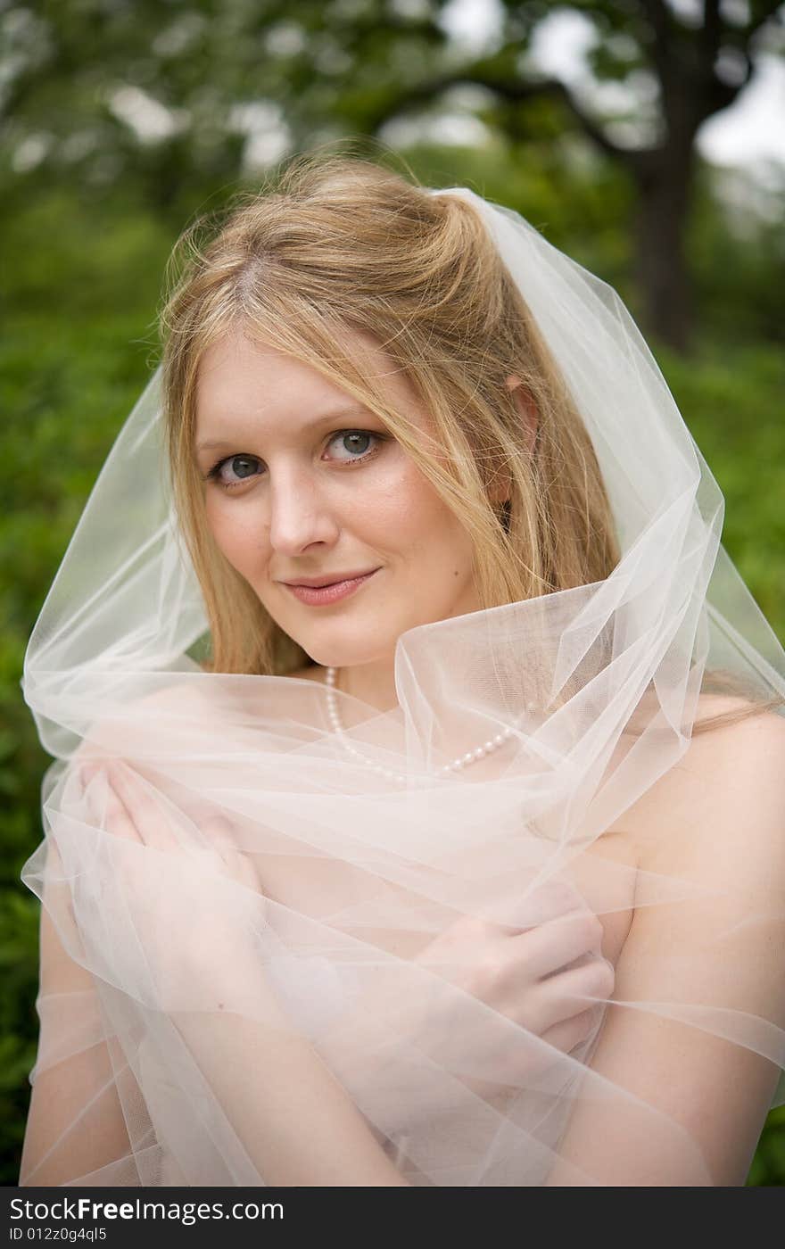 Bride with her veil wrapped around her