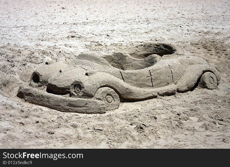 Car made from sand on a beach. Car made from sand on a beach.