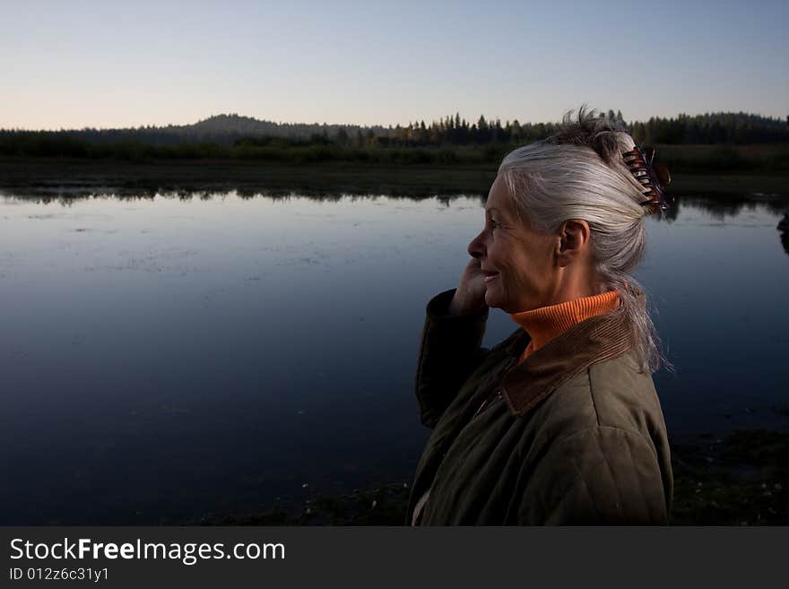 Senior woman looking at lake. Senior woman looking at lake