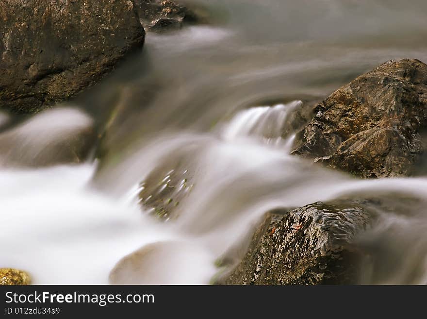 Water flowing smoothly over rocks. Water flowing smoothly over rocks