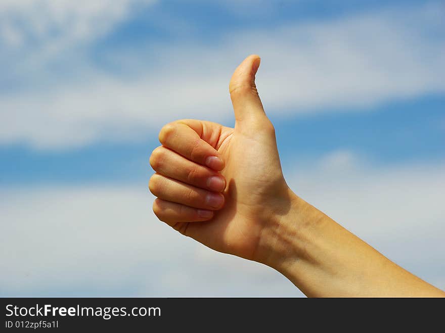 Womans hand with thumb up ok signal