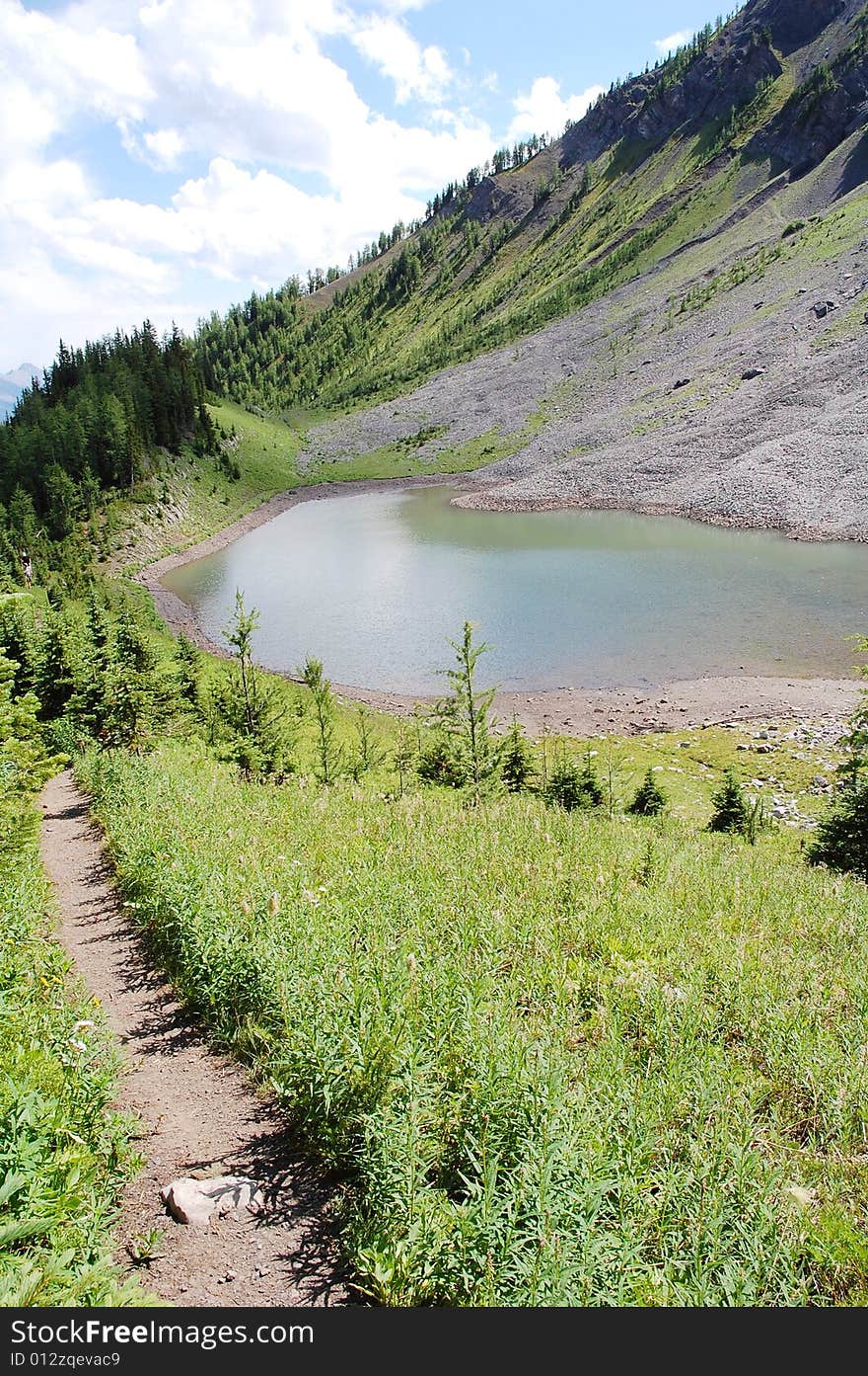 Alpine lake on mountains indefatigable, kananaskis country, alberta, canada