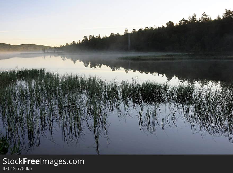 Morning fog and reflection on lake